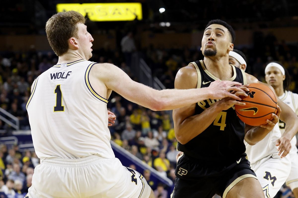 Feb 11, 2025; Ann Arbor, Michigan, USA;  Purdue Boilermakers forward Trey Kaufman-Renn (4) is defended by Michigan Wolverines center Danny Wolf (1) in the second half at Crisler Center. Mandatory Credit: Rick Osentoski-Imagn Images