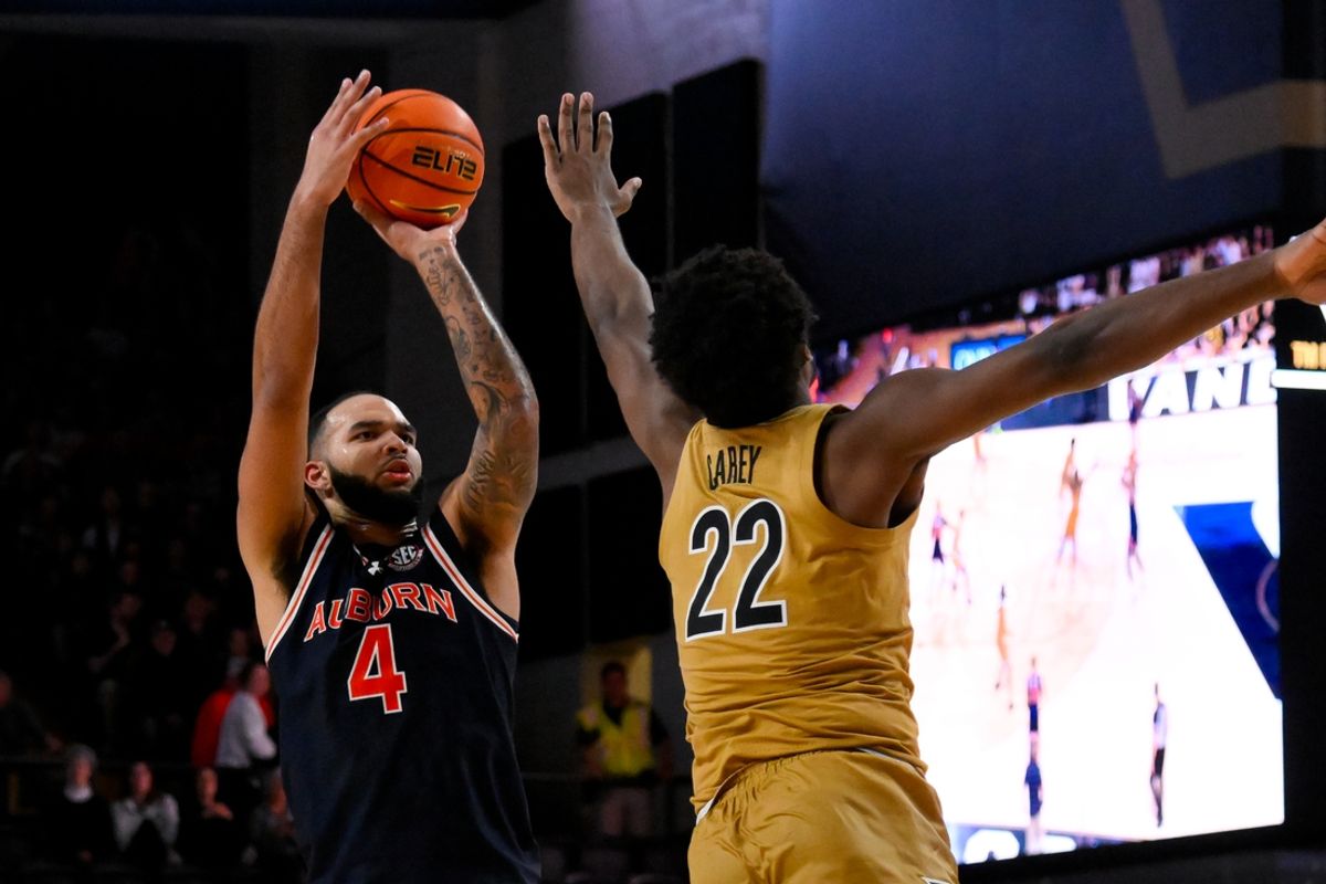 Feb 11, 2025; Nashville, Tennessee, USA; Auburn Tigers forward Johni Broome (4) shoots over Vanderbilt Commodores forward Jaylen Carey (22) during the second half at Memorial Gymnasium. Mandatory Credit: Steve Roberts-Imagn Images
