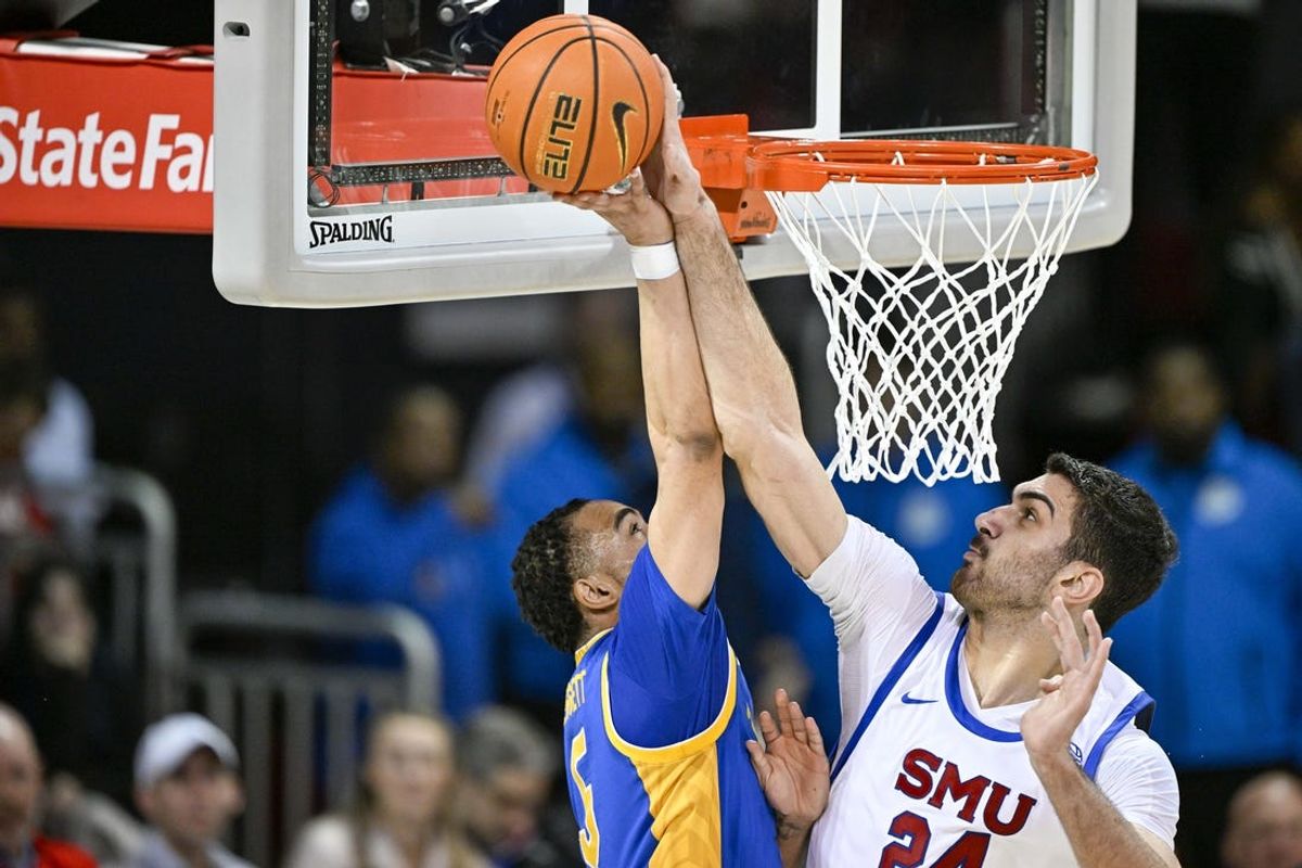 Feb 11, 2025; Dallas, Texas, USA; Southern Methodist Mustangs center Samet Yigitoglu (24) blocks a shot by Pittsburgh Panthers guard Ishmael Leggett (5) during the first half at Moody Coliseum. Mandatory Credit: Jerome Miron-Imagn Images