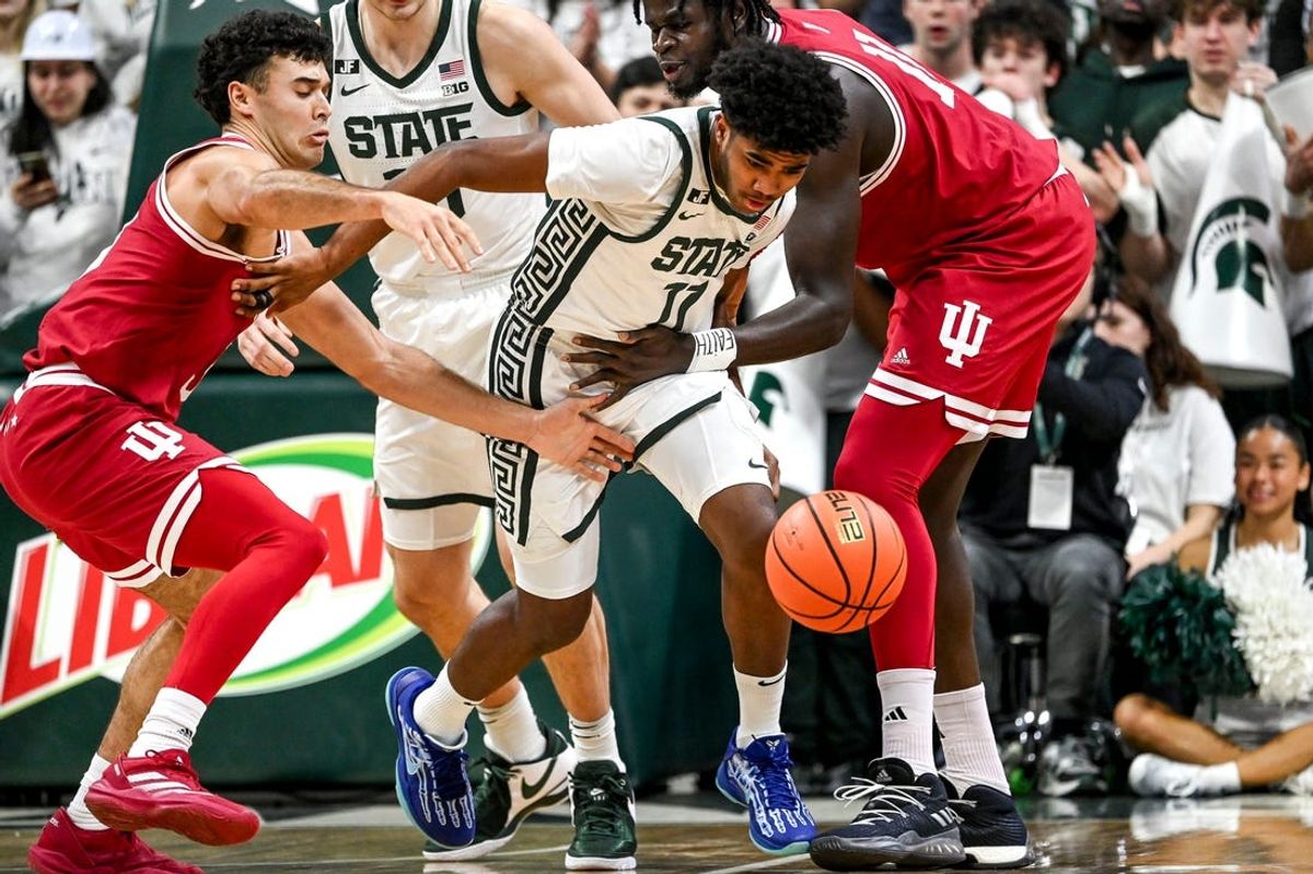 Michigan State's Jase Richardson takes off with the ball between Indiana's defense during the first half on Tuesday, Feb. 11, 2025, at the Breslin Center in East Lansing.