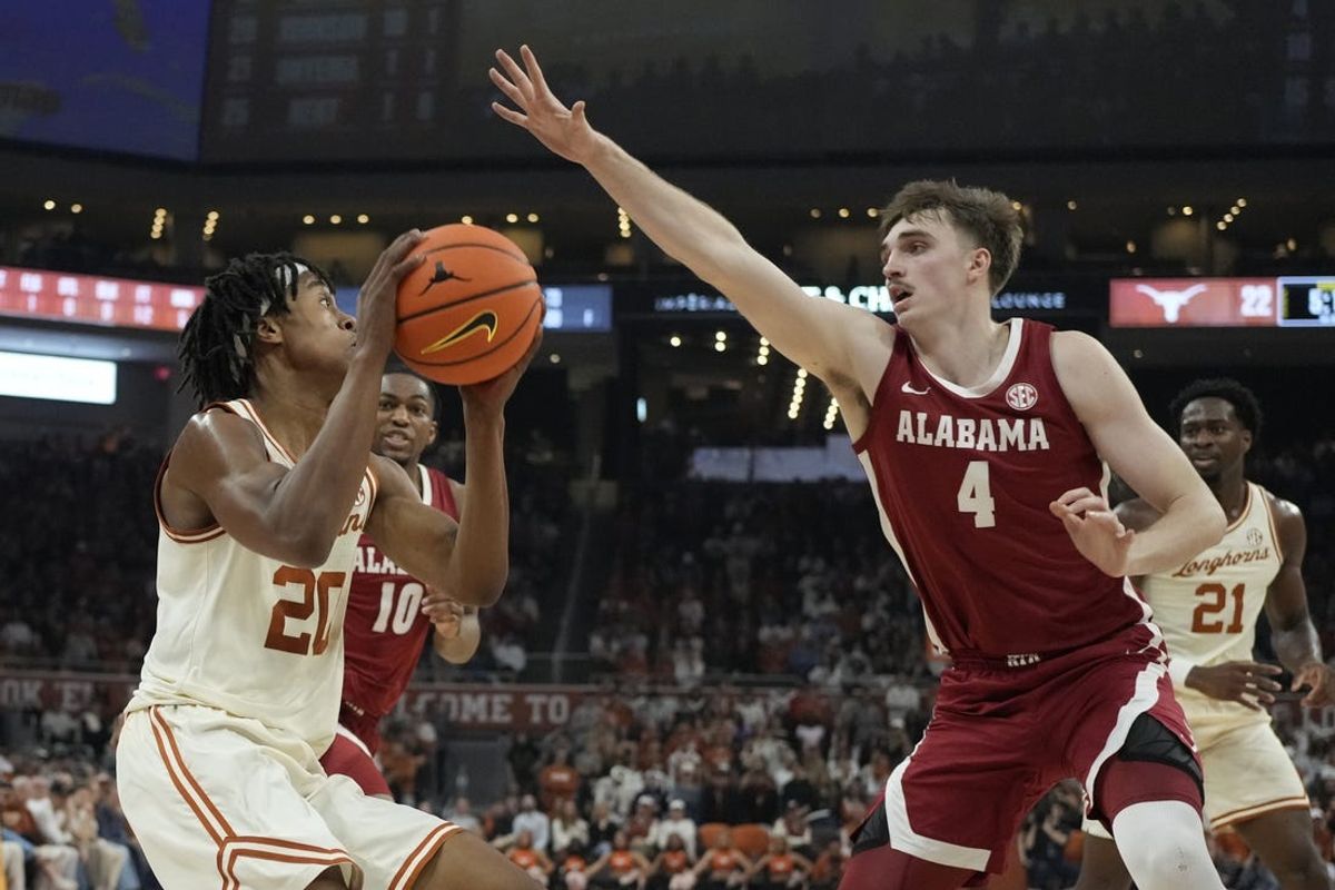 Feb 11, 2025; Austin, Texas, USA; Texas Longhorns guard Tre Johnson (20) shoots over Alabama Crimson Tide forward Grant Nelson (4) during the first half at Moody Center. Mandatory Credit: Scott Wachter-Imagn Images