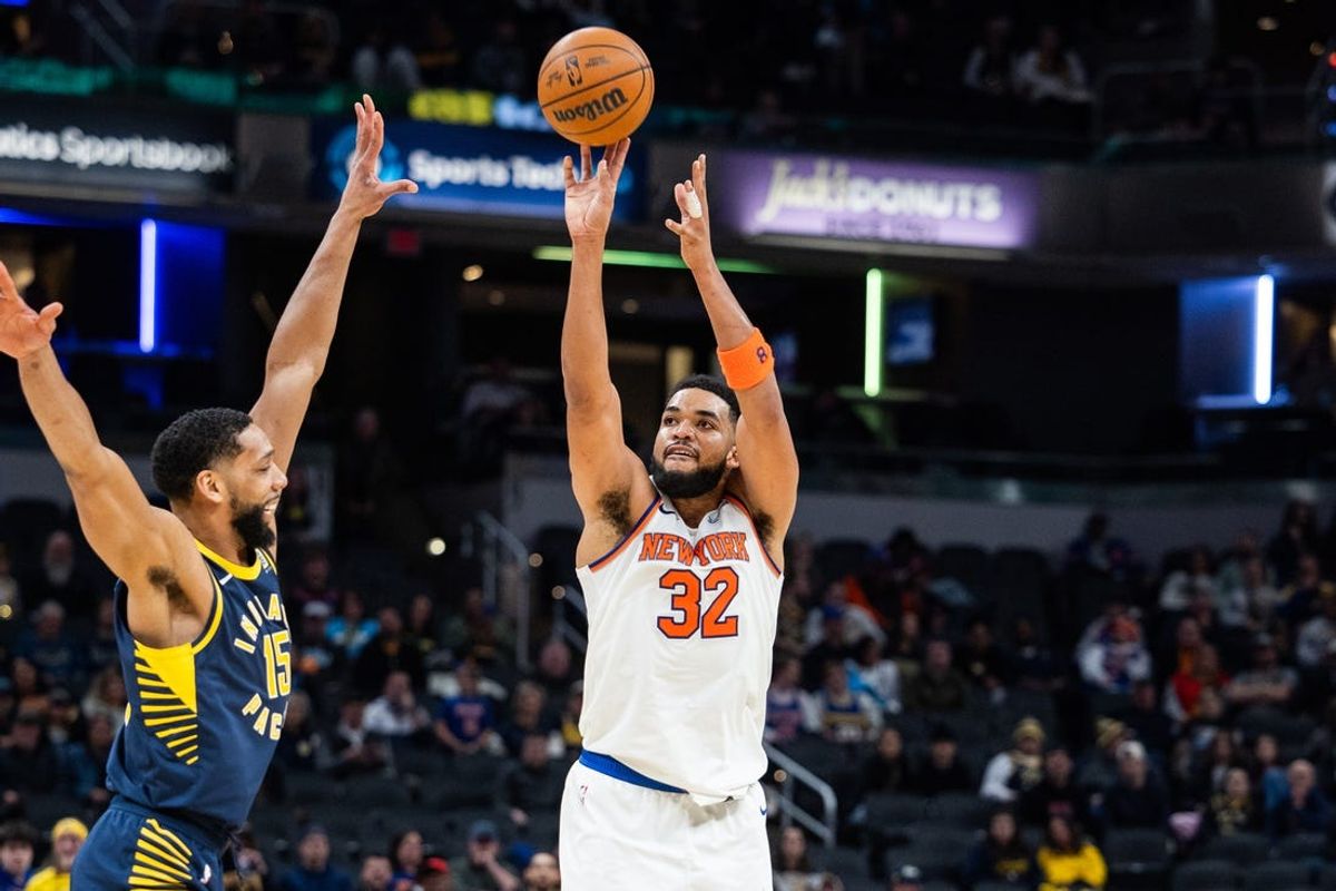 Feb 11, 2025; Indianapolis, Indiana, USA; New York Knicks center Karl-Anthony Towns (32) shoots the ball while Indiana Pacers center Jahlil Okafor (15) defends in the second half at Gainbridge Fieldhouse. Mandatory Credit: Trevor Ruszkowski-Imagn Images