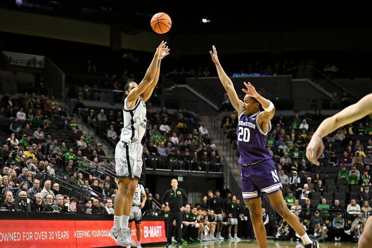 Feb 11, 2025; Eugene, Oregon, USA; Oregon Ducks guard TJ Bamba (5) shoots a three-point shot over Northwestern Wildcats guard Justin Mullins (20) during the first half at Matthew Knight Arena. Mandatory Credit: Craig Strobeck-Imagn Images