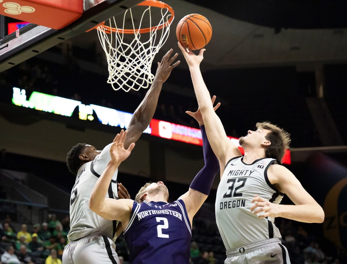 Oregon center Nate Bittle rebounds the ball over Northwestern forward Nick Martinelli as the Oregon Ducks host the Northwestern Wildcats Tuesday, Feb. 11, 2025, at Matthew Knight Arena in Eugene, Ore.
