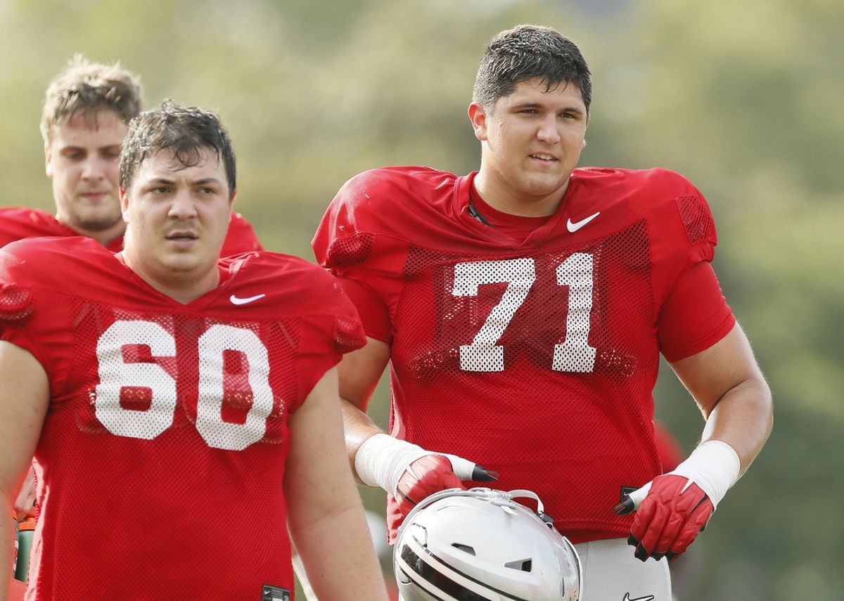 Ohio State Buckeyes offensive lineman Ben Christman (71) runs beside Ryan Smith (60) during football training camp at the Woody Hayes Athletic Center in Columbus on Tuesday, Aug. 10, 2021.