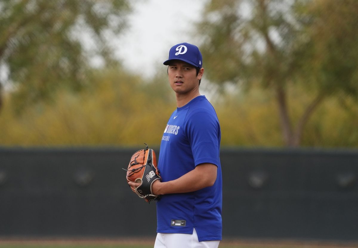 Feb 12, 2025; Glendale, AZ, USA; Los Angeles Dodgers two-way player Shohei Ohtani (17) looks on during a Spring Training workout at Camelback Ranch. Mandatory Credit: Joe Camporeale-Imagn Images