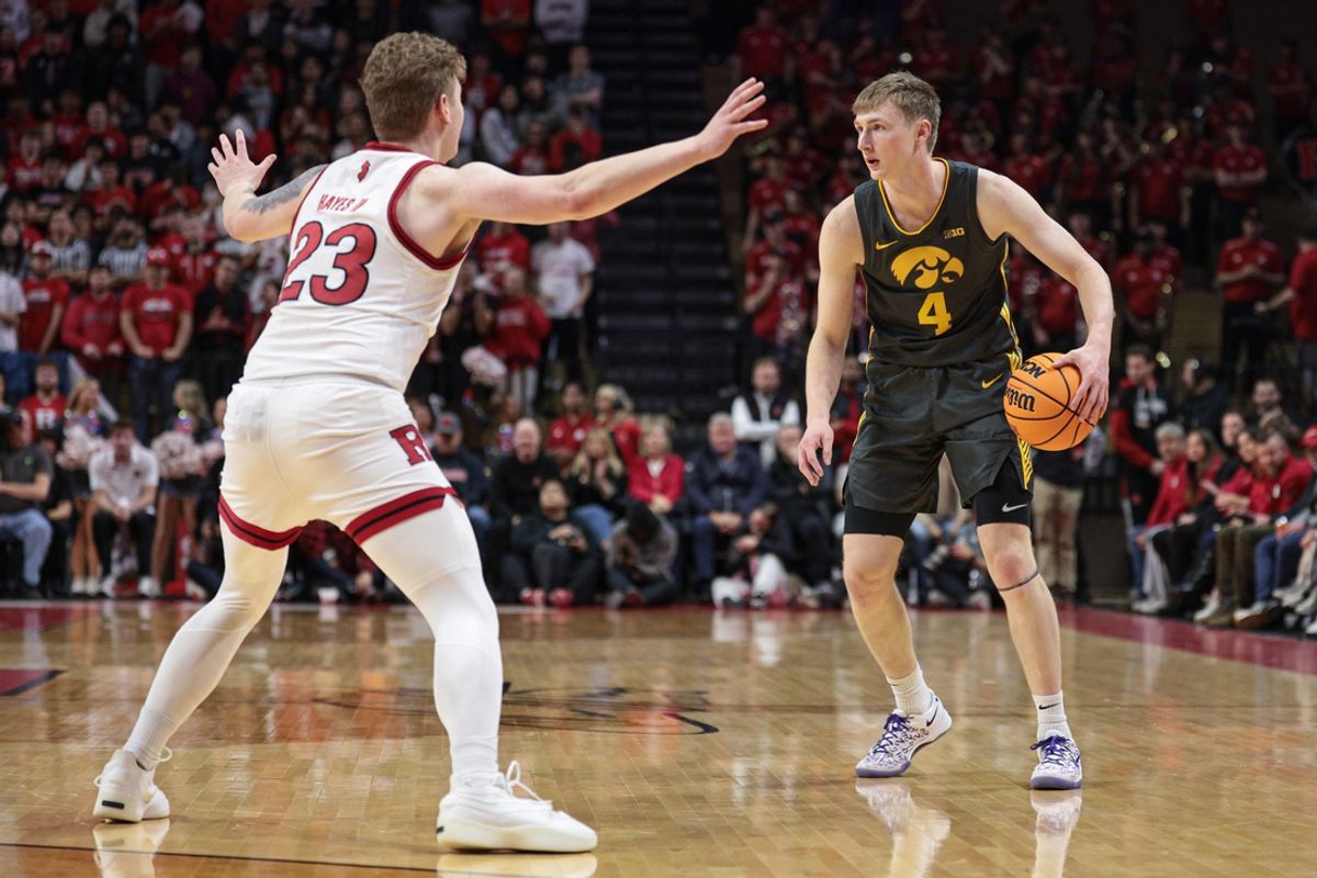 Feb 12, 2025; Piscataway, New Jersey, USA; Iowa Hawkeyes guard Josh Dix (4) is guarded by Rutgers Scarlet Knights guard PJ Hayes IV (23) during the first half at Jersey Mike's Arena. Mandatory Credit: Vincent Carchietta-Imagn Images