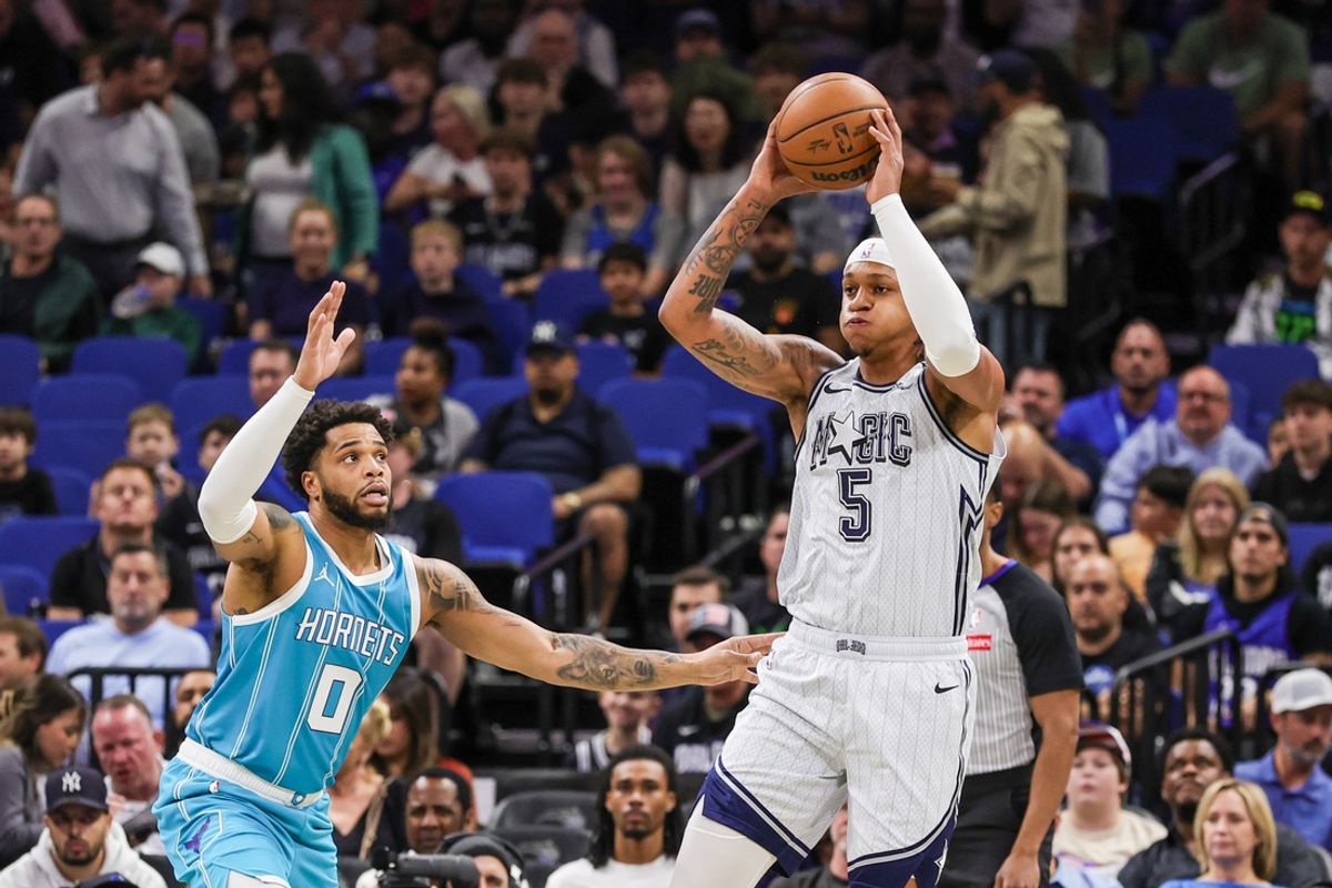 Feb 12, 2025; Orlando, Florida, USA; Orlando Magic forward Paolo Banchero (5) passes the ball in front of Charlotte Hornets forward Miles Bridges (0) during the first quarter at Kia Center. Mandatory Credit: Mike Watters-Imagn Images