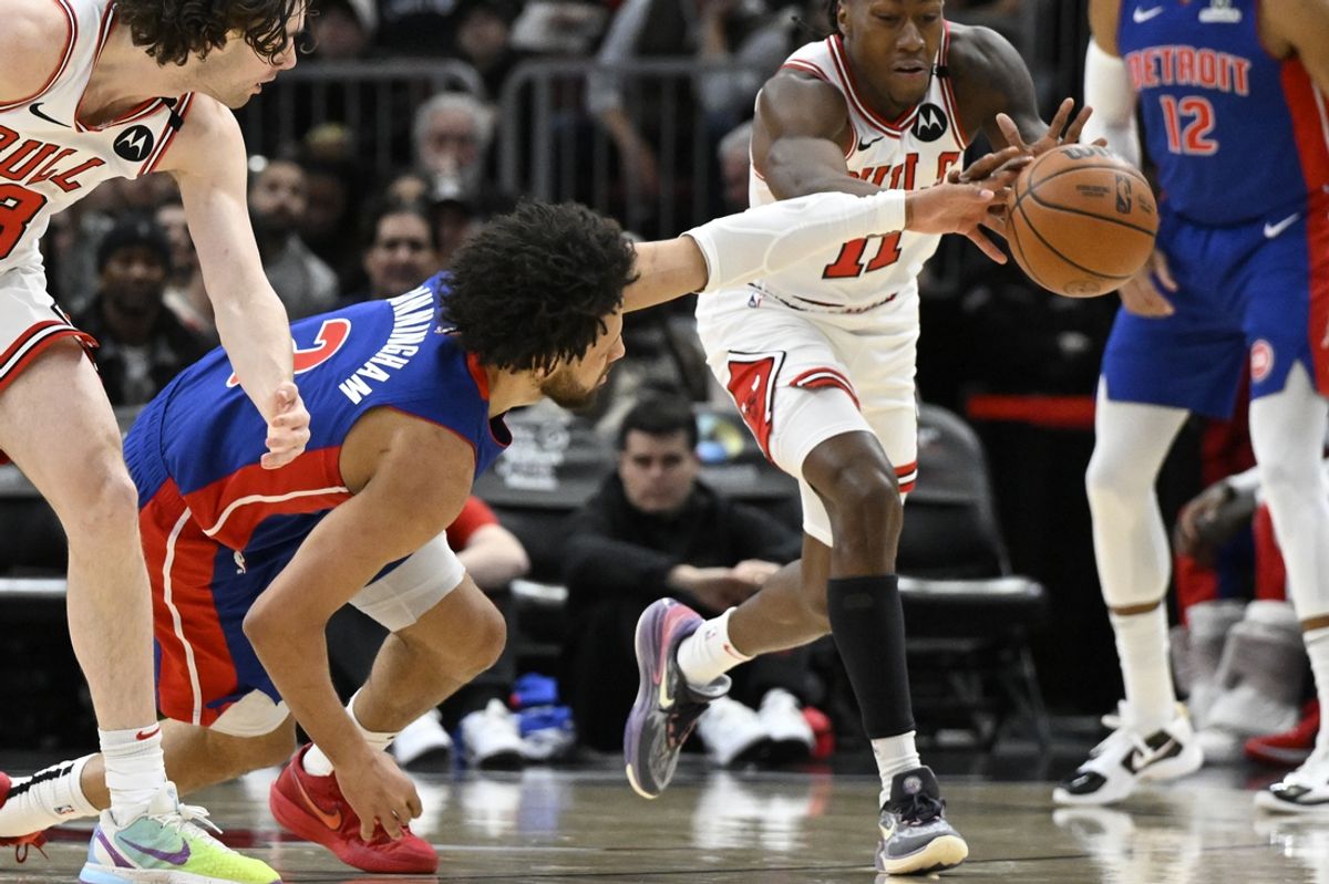 Feb 12, 2025; Chicago, Illinois, USA;  Detroit Pistons guard Cade Cunningham (2) chases a loose ball against Chicago Bulls guard Josh Giddey (3) and guard Ayo Dosunmu (11) during the first half at the United Center. Mandatory Credit: Matt Marton-Imagn Images