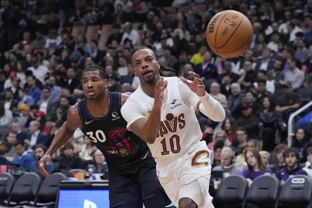 Feb 12, 2025; Toronto, Ontario, CAN; Cleveland Cavaliers guard Darius Garland (10) takes a pass as Toronto Raptors guard Ochai Agbaji (30) defends during the first half at Scotiabank Arena. Mandatory Credit: John E. Sokolowski-Imagn Images