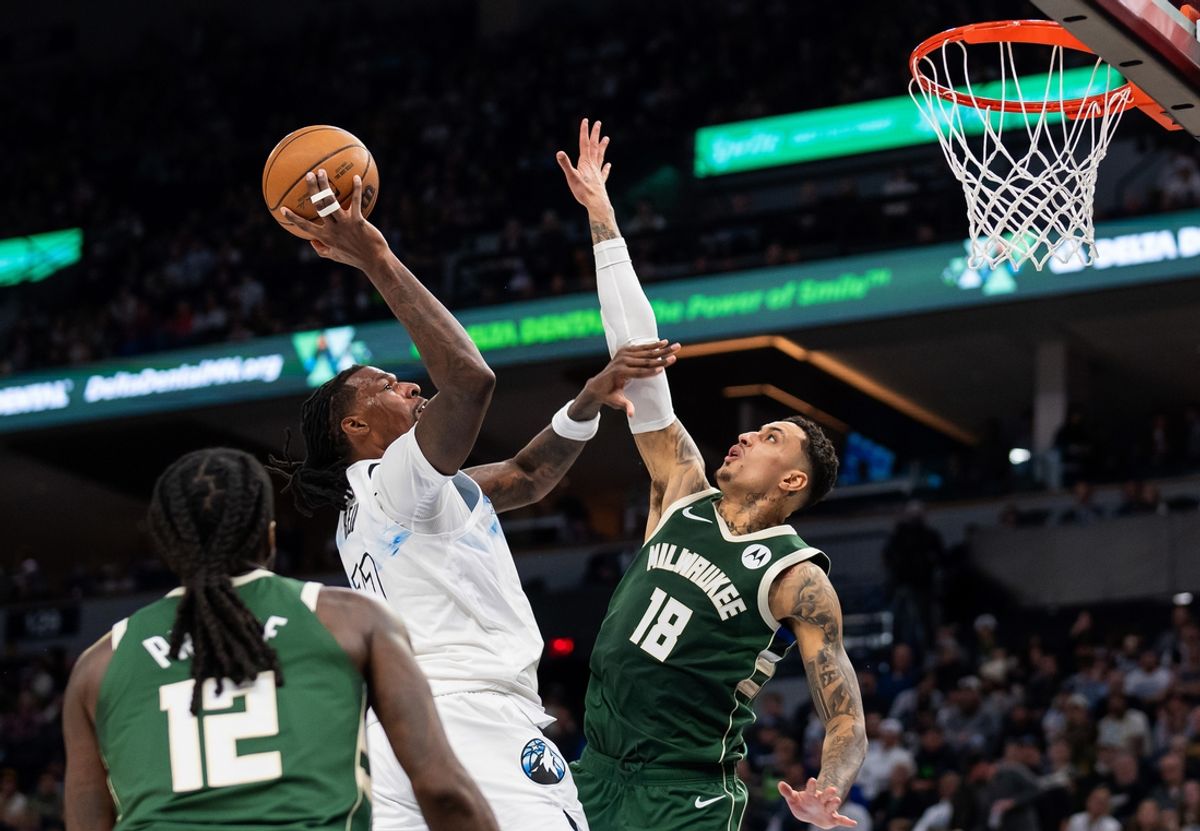 Feb 12, 2025; Minneapolis, Minnesota, USA; Minnesota Timberwolves center Naz Reid (11) shoots against Milwaukee Bucks forward Kyle Kuzma (18) in the second quarter at Target Center. Mandatory Credit: Brad Rempel-Imagn Images