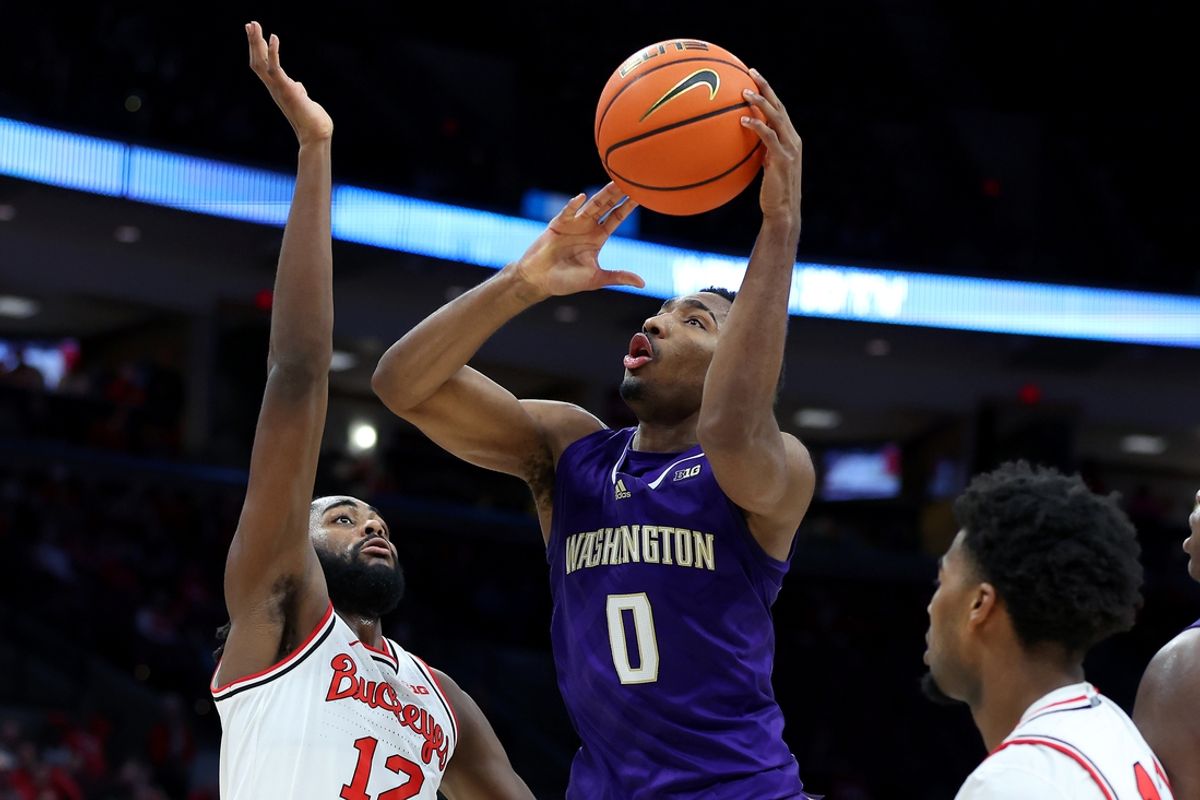 Feb 12, 2025; Columbus, Ohio, USA;  Washington Huskies guard Mekhi Mason (0) shoots the ball as Ohio State Buckeyes guard Evan Mahaffey (12) defends during the first half at Value City Arena. Mandatory Credit: Joseph Maiorana-Imagn Images
