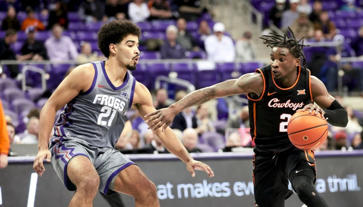 Feb 12, 2025; Fort Worth, Texas, USA; Oklahoma State Cowboys guard Arturo Dean (2) drives to the basket as TCU Horned Frogs guard Noah Reynolds (21) defends during the second half at Ed and Rae Schollmaier Arena. Mandatory Credit: Kevin Jairaj-Imagn Images
