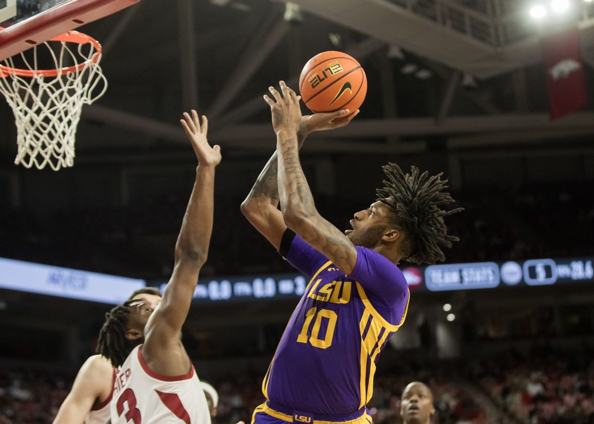 Feb 12, 2025; Fayetteville, Arkansas, USA; LSU Tigers forward Daimion Collins (10) shoots over Arkansas Razorbacks forward Adou Thiero (3) during the first half at Bud Walton Arena. Mandatory Credit: Brett Rojo-Imagn Images