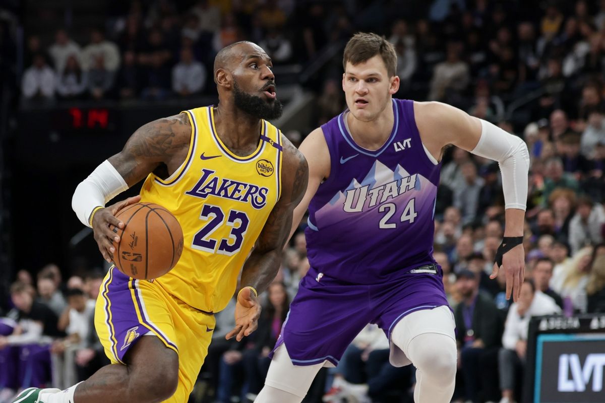 Feb 12, 2025; Salt Lake City, Utah, USA;  Los Angeles Lakers forward LeBron James (23) dribbles past Utah Jazz center Walker Kessler (24) during the first quarter at Delta Center. Mandatory Credit: Chris Nicoll-Imagn Images