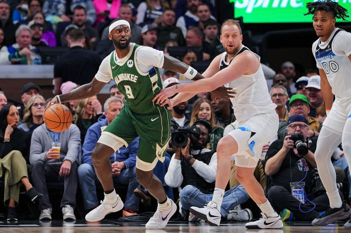 Feb 12, 2025; Minneapolis, Minnesota, USA; Milwaukee Bucks forward Bobby Portis (9) dribbles against the Minnesota Timberwolves guard Joe Ingles (7) in the second quarter at Target Center. Mandatory Credit: Brad Rempel-Imagn Images