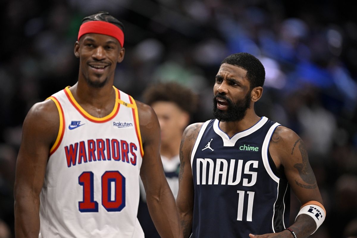 Feb 12, 2025; Dallas, Texas, USA; Golden State Warriors forward Jimmy Butler (10) laughs as Dallas Mavericks guard Kyrie Irving (11) argues a call during the second half at the American Airlines Center. Mandatory Credit: Jerome Miron-Imagn Images