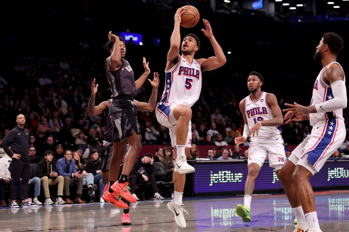 Feb 12, 2025; Brooklyn, New York, USA; Philadelphia 76ers guard Quentin Grimes (5) drives to the basket against Brooklyn Nets guard Reece Beekman (4) during the fourth quarter at Barclays Center. Mandatory Credit: Brad Penner-Imagn Images