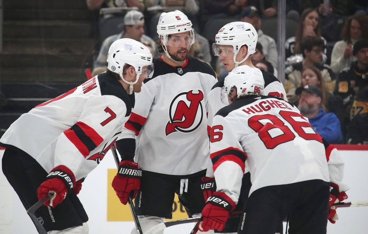 Feb 4, 2025; Pittsburgh, Pennsylvania, USA;  New Jersey Devils defensemen Dougie Hamilton (7) and Brenden Dillon (5) and left wing Jesper Bratt (63) and center Jack Hughes (86) talk before face-off against the Pittsburgh Penguins during the second period at PPG Paints Arena. Mandatory Credit: Charles LeClaire-Imagn Images