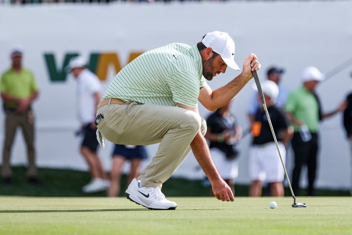 Feb 8, 2025; Scottsdale, Arizona, USA; Scottie Scheffler of the United States places his ball down on the green at hole 16 during the third round of the WM Phoenix Open golf tournament. Mandatory Credit: Aryanna Frank-Imagn Images