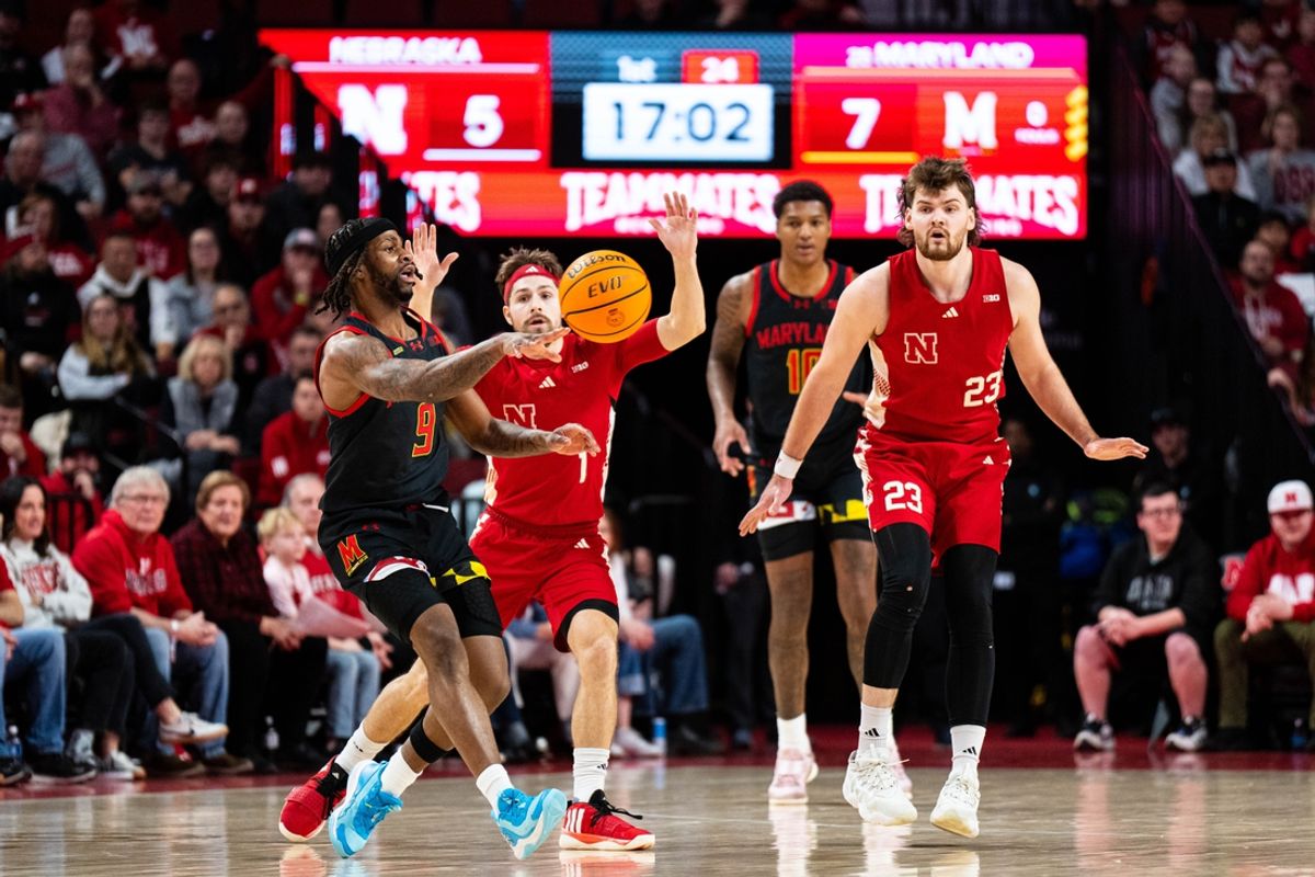 Feb 13, 2025; Lincoln, Nebraska, USA; Maryland Terrapins guard Selton Miguel (9) passes against Nebraska Cornhuskers guard Sam Hoiberg (1) during the first half at Pinnacle Bank Arena. Mandatory Credit: Dylan Widger-Imagn Images