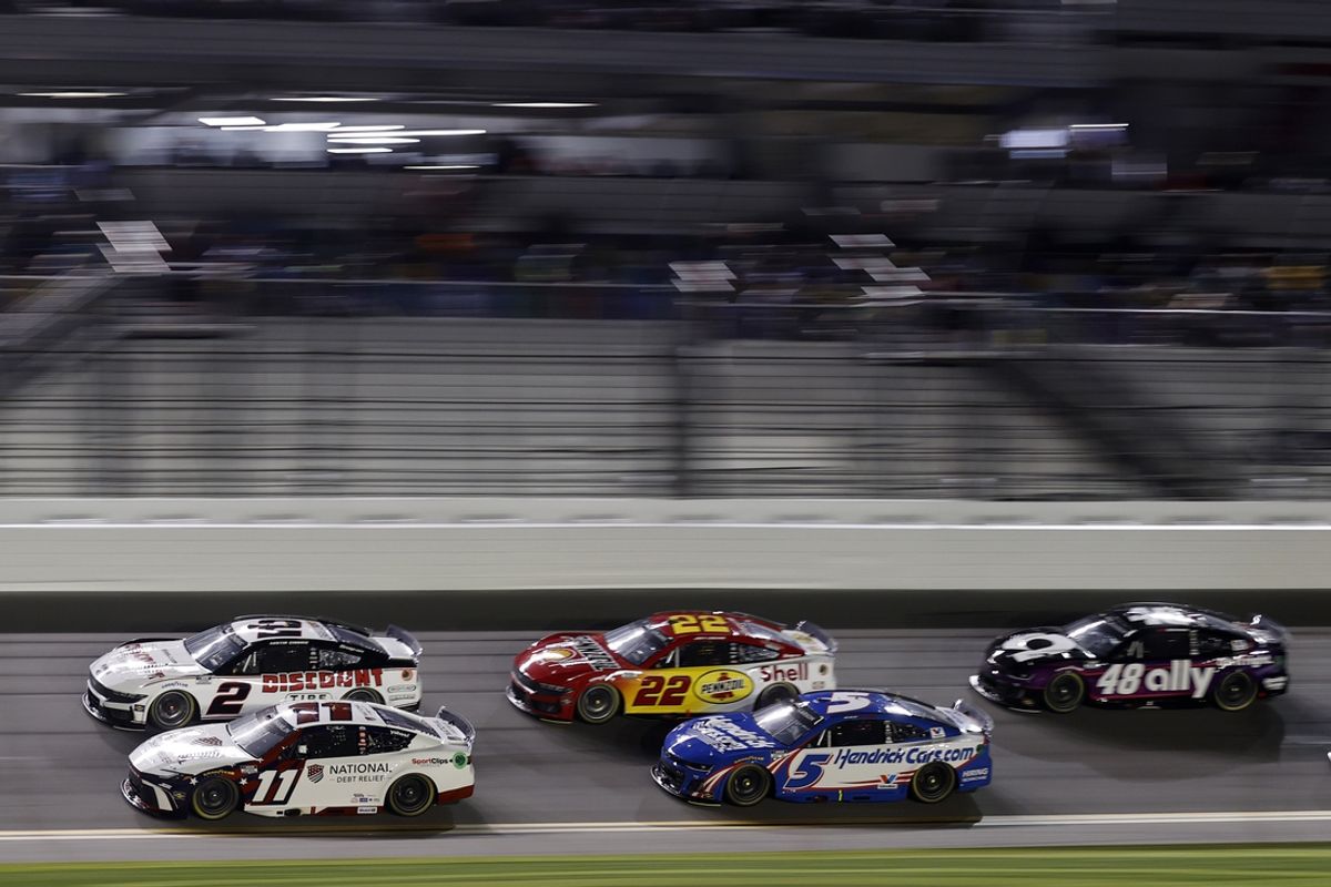 Feb 13, 2025; Daytona Beach, Florida, USA; NASCAR Cup Series driver Denny Hamlin (11) and driver Austin Cindric (2) race side by side during Duel 2 at Daytona International Speedway. Mandatory Credit: Peter Casey-Imagn Images