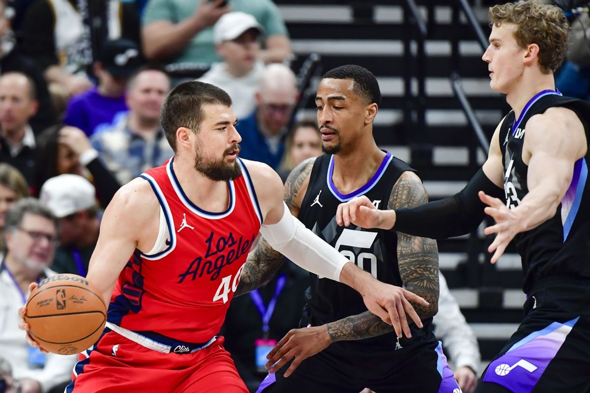 Feb 13, 2025; Salt Lake City, Utah, USA; LA Clippers center Ivica Zubac (40) turns into Utah Jazz forward/center John Collins (20) and forward/center Lauri Markkanen (23) during the first half at the Delta Center. Mandatory Credit: Christopher Creveling-Imagn Images