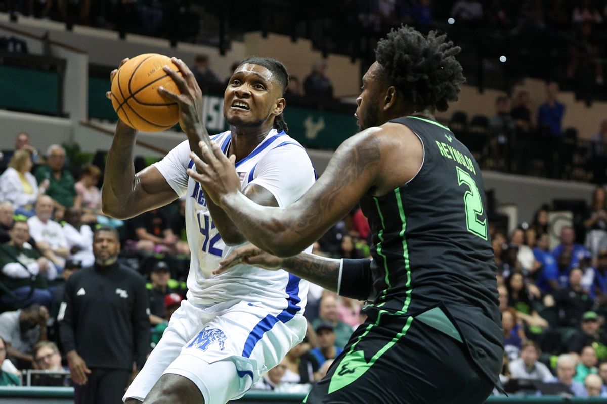 Feb 13, 2025; Tampa, Florida, USA; Memphis Tigers forward Dain Dainja (42) shoots the ball over South Florida Bulls forward Jamille Reynolds (2) in the first half at Yuengling Center. Mandatory Credit: Nathan Ray Seebeck-Imagn Images