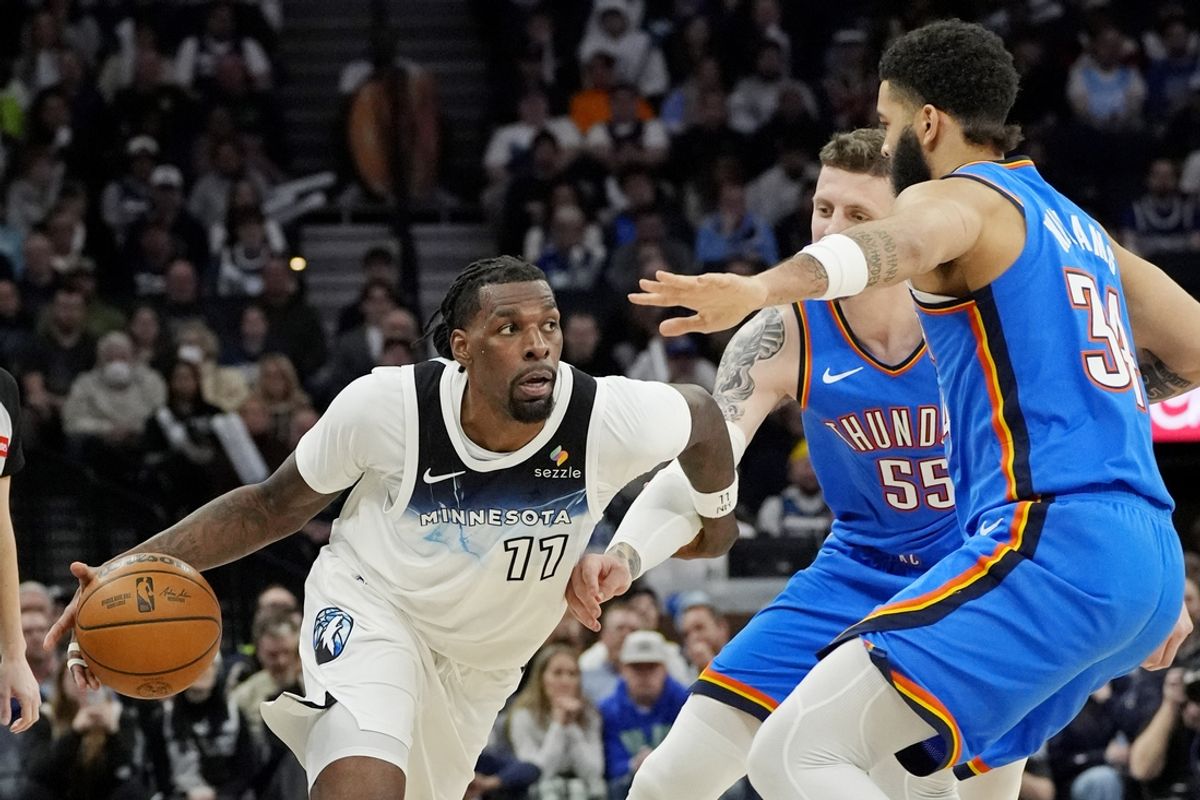 Feb 13, 2025; Minneapolis, Minnesota, USA; Minnesota Timberwolves center Naz Reid (11) dribbles around Oklahoma City Thunder center Isaiah Hartenstein (55) and guard Kenrich Williams (34) in the fourth quarter at Target Center. Mandatory Credit: Bruce Kluckhohn-Imagn Images