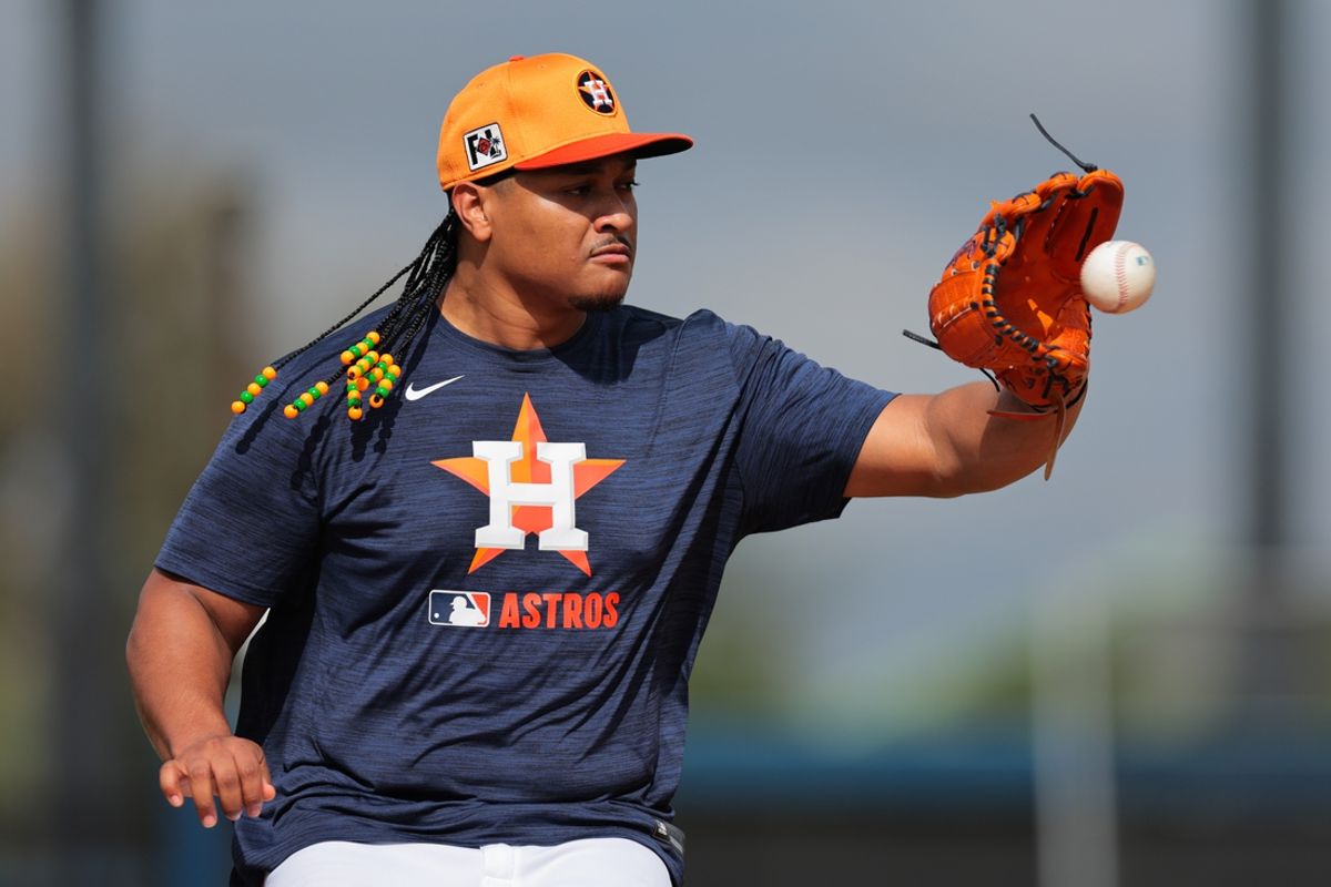 Feb 14, 2025; West Palm Beach, FL, USA; Houston Astros starting pitcher Luis Garcia (77) works on a fielding exercise during a spring training workout at CACTI Park of the Palm Beaches. Mandatory Credit: Sam Navarro-Imagn Images