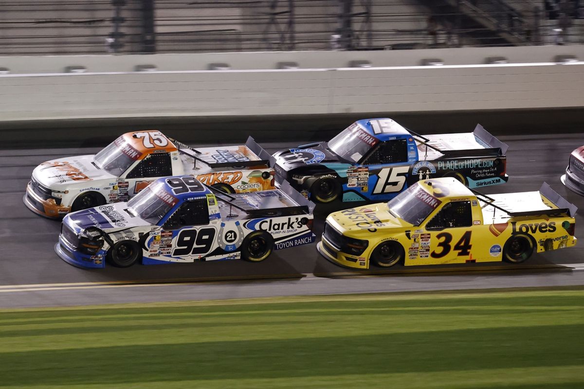 Feb 14, 2025; Daytona Beach, Florida, USA; NASCAR Truck Series driver Ben Rhodes (99) and driver Parker Kligerman (75) race side by side during the Fresh From Florida 250 at Daytona International Speedway. Mandatory Credit: Peter Casey-Imagn Images