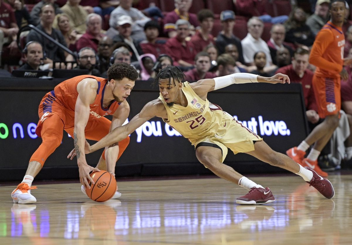 Feb 15, 2025; Tallahassee, Florida, USA; Clemson Tigers guard Chase Hunter (1) reaches for a loose ball as Florida State Seminoles guard Justin Thomas (25) dives for the ball during the first half at Donald L. Tucker Center. Mandatory Credit: Melina Myers-Imagn Images