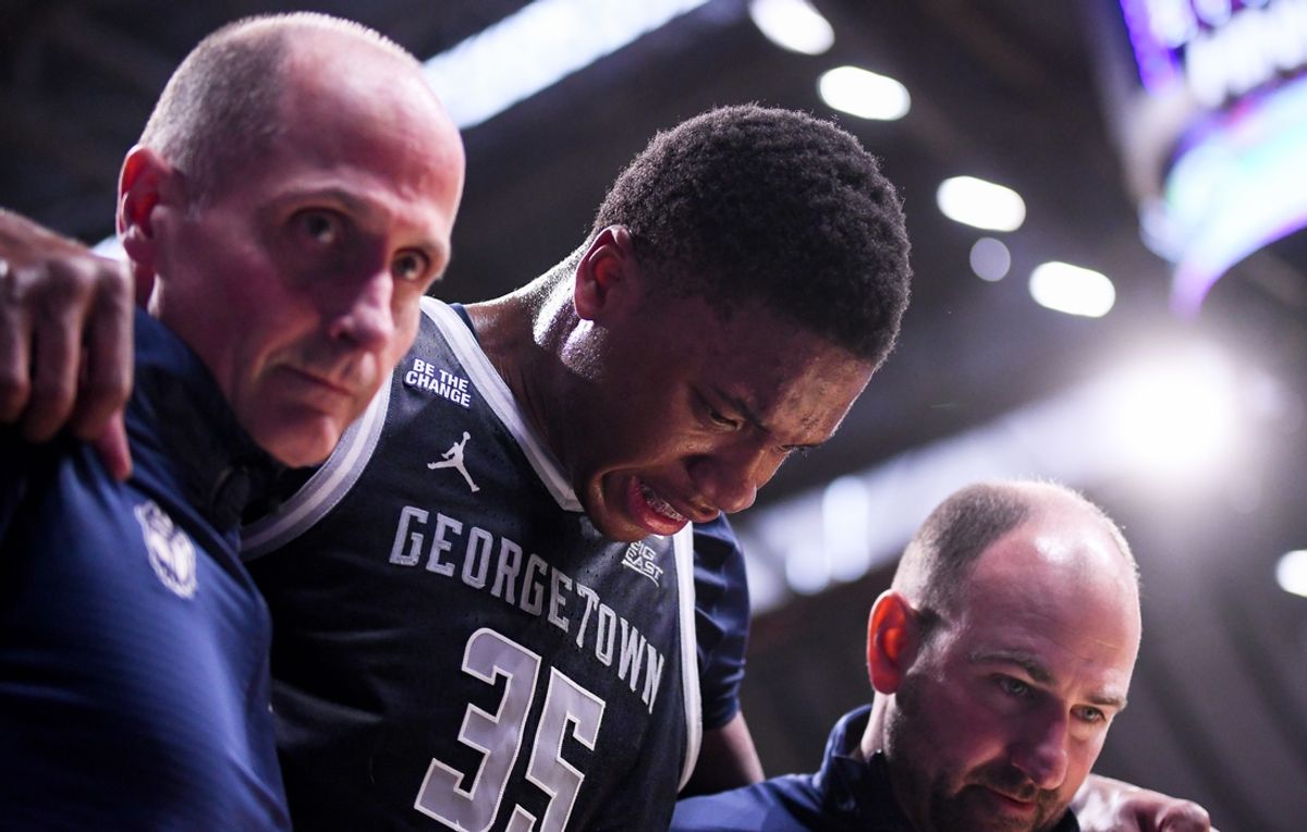 Feb 15, 2025; Indianapolis, Indiana, USA; Georgetown Hoyas forward Thomas Sorber (35) is helped off the court after an injury during the first half against the Butler Bulldogs at Hinkle Fieldhouse. Mandatory Credit: Robert Goddin-Imagn Images