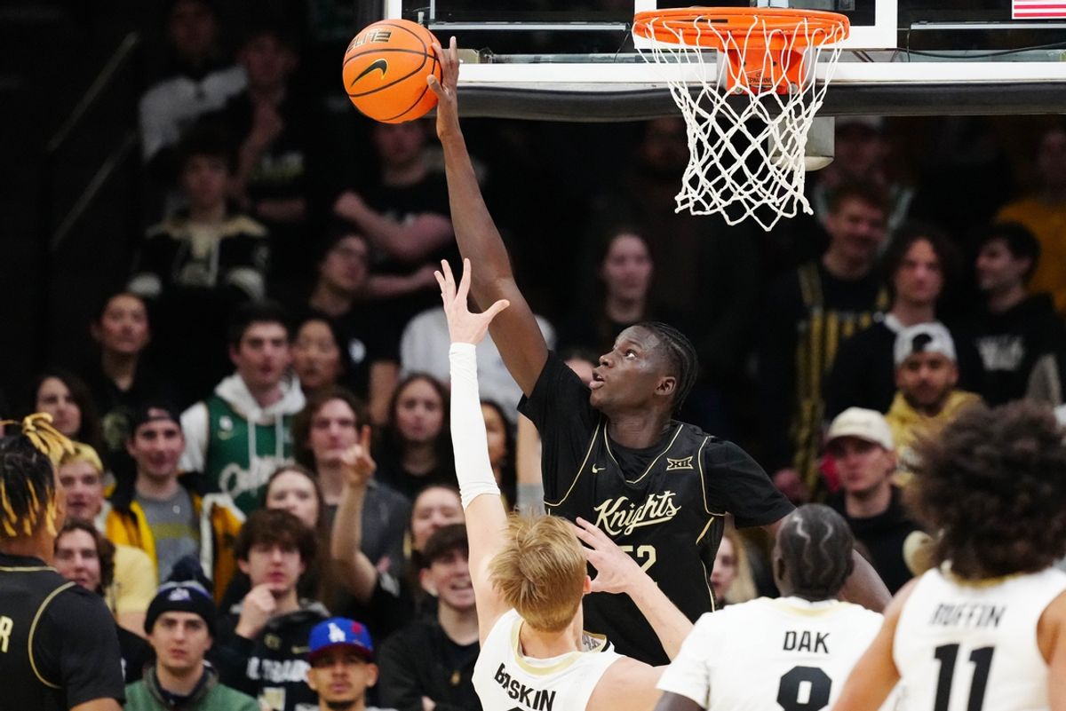 Feb 15, 2025; Boulder, Colorado, USA; UCF Knights center Moustapha Thiam (52) blocks the shot of Colorado Buffaloes forward Trevor Baskin (6) in the first half at the CU Events Center. Mandatory Credit: Ron Chenoy-Imagn Images