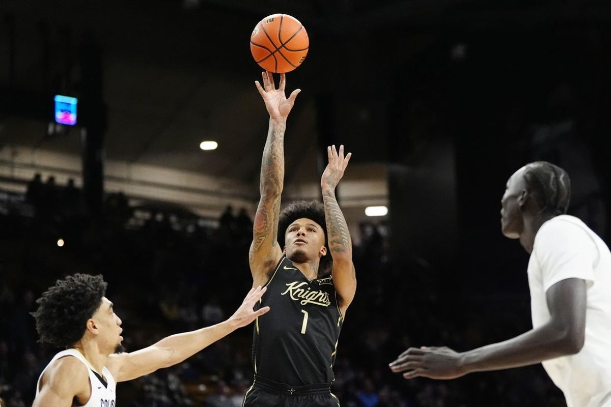 Feb 15, 2025; Boulder, Colorado, USA; UCF Knights guard Mikey Williams (1) shoots the ball in the first half against the Colorado Buffaloes at the CU Events Center. Mandatory Credit: Ron Chenoy-Imagn Images