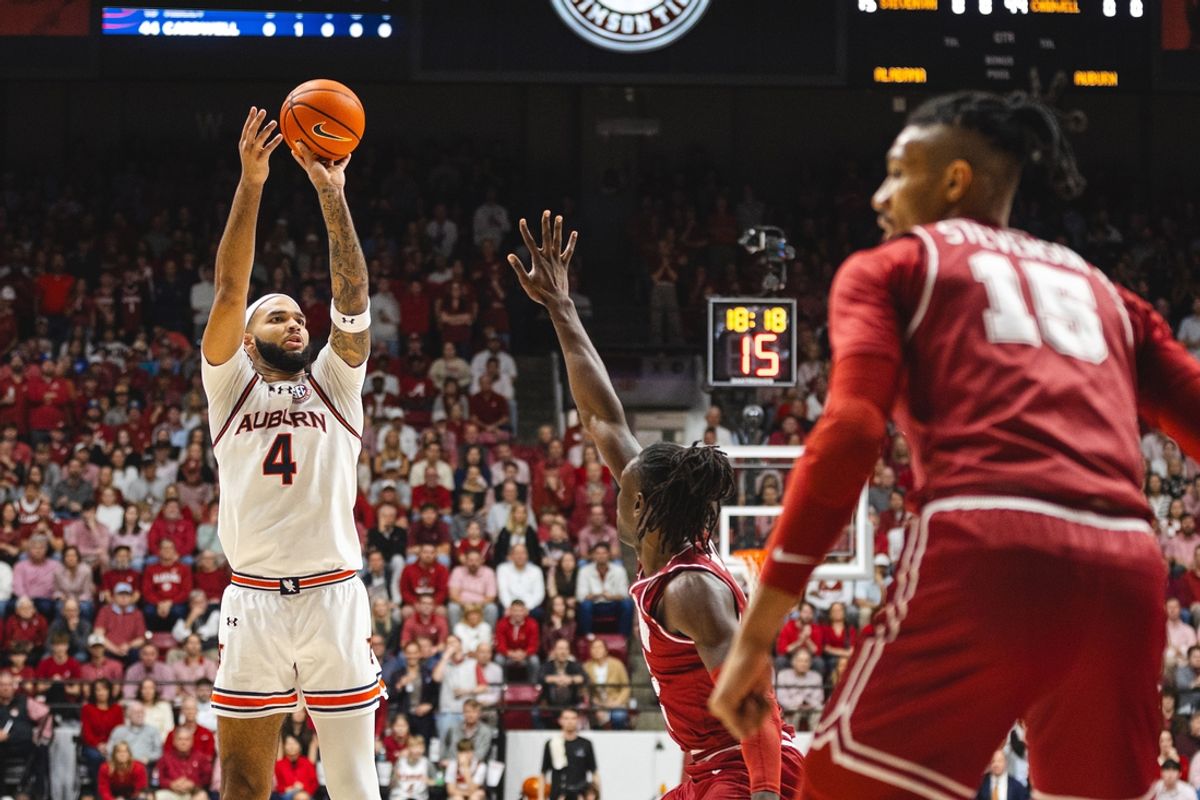 Feb 15, 2025; Tuscaloosa, Alabama, USA; Auburn Tigers forward Johni Broome (4) shoots a three point basket against Alabama Crimson Tide center Clifford Omoruyi (11) during the first half at Coleman Coliseum. Mandatory Credit: Will McLelland-Imagn Images