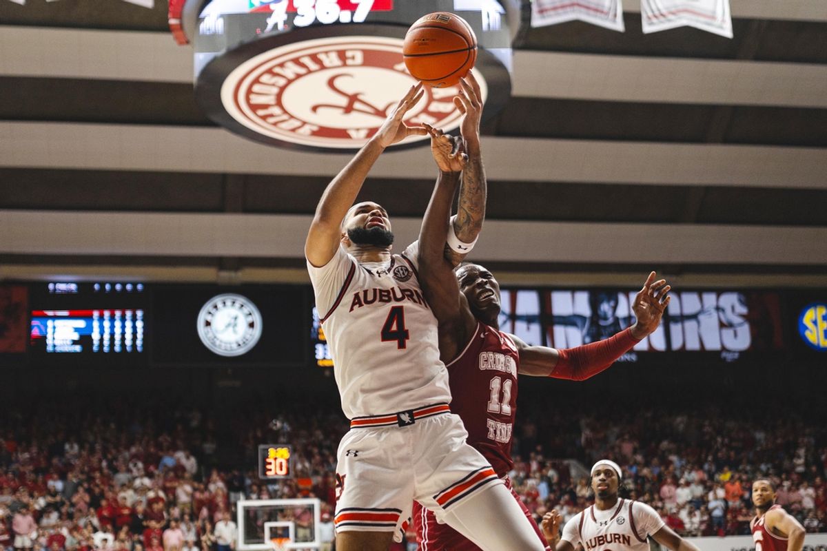Feb 15, 2025; Tuscaloosa, Alabama, USA; Auburn Tigers forward Johni Broome (4) and Alabama Crimson Tide center Clifford Omoruyi (11) struggle over a rebound during the first half at Coleman Coliseum. Mandatory Credit: Will McLelland-Imagn Images