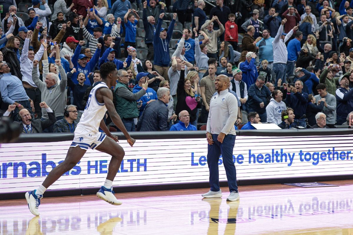 Feb 15, 2025; Newark, New Jersey, USA; Seton Hall Pirates head coach Shaheen Holloway and center Godswill Erheriene (54) celebrate after defeating the Connecticut Huskies in overtime at Prudential Center. Mandatory Credit: Vincent Carchietta-Imagn Images