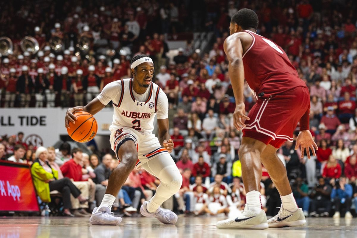Feb 15, 2025; Tuscaloosa, Alabama, USA; Auburn Tigers guard Denver Jones (2) dribbles the ball against Alabama Crimson Tide guard Chris Youngblood (8) during the first half at Coleman Coliseum. Mandatory Credit: Will McLelland-Imagn Images
