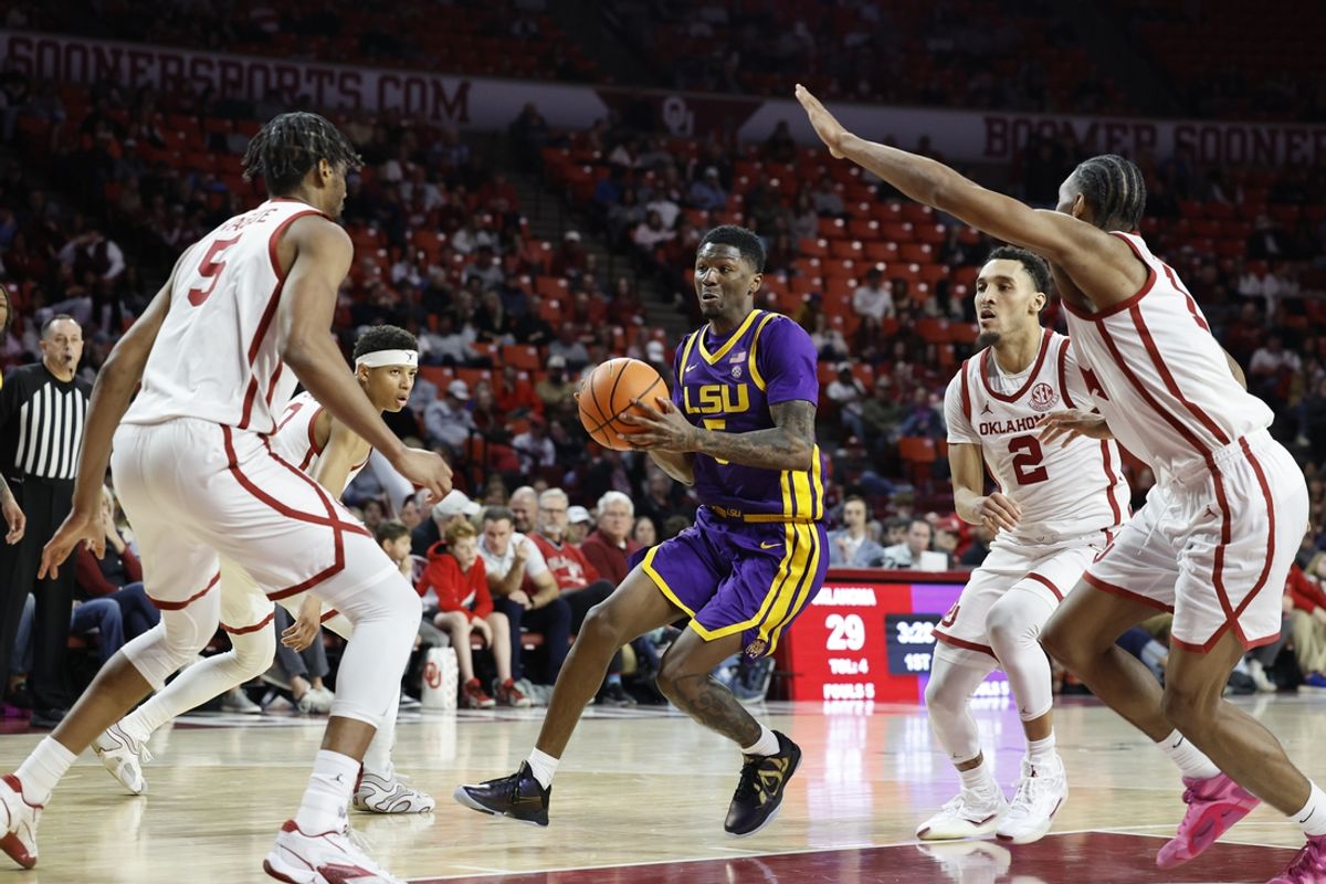 Feb 15, 2025; Norman, Oklahoma, USA; LSU Tigers guard Cam Carter (5) drives to the basket against the Oklahoma Sooners during the first half at Lloyd Noble Center. Mandatory Credit: Alonzo Adams-Imagn Images