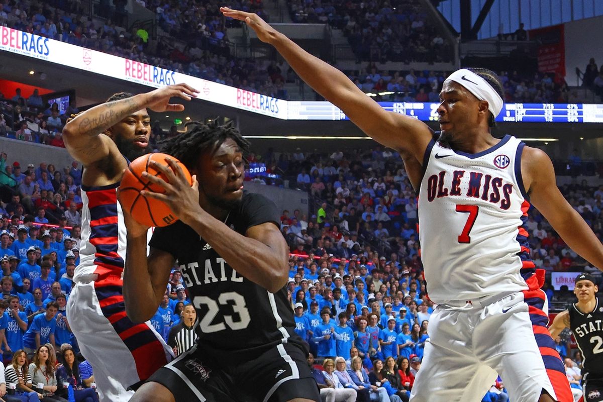 Feb 15, 2025; Oxford, Mississippi, USA; Mississippi State Bulldogs center Michael Nwoko (23) handles the ball as Mississippi Rebels forward Mikeal Brown-Jones (1) and guard Davon Barnes (7) defend during the first half at The Sandy and John Black Pavilion at Ole Miss. Mandatory Credit: Petre Thomas-Imagn Images