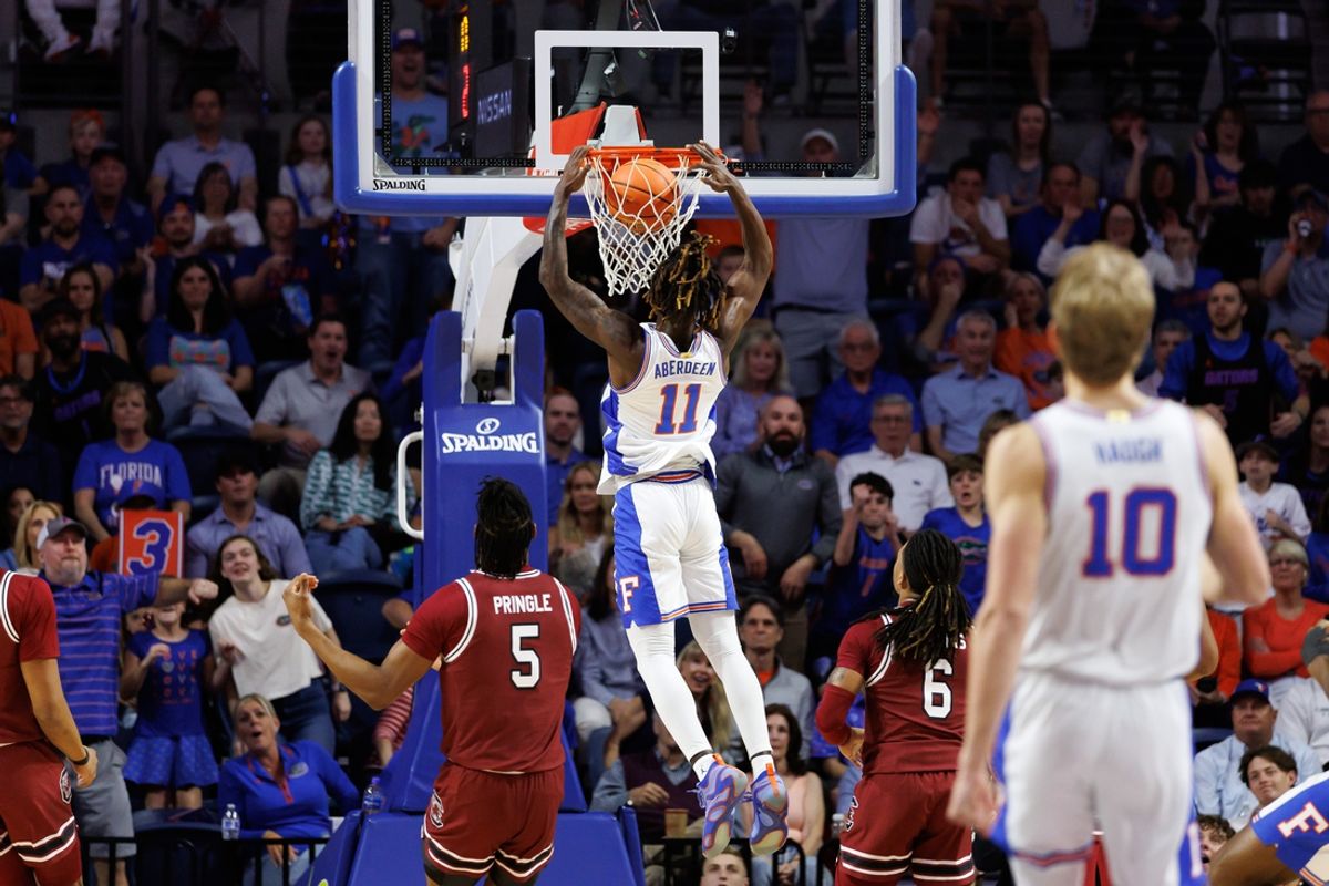 Feb 15, 2025; Gainesville, Florida, USA; Florida Gators guard Denzel Aberdeen (11) dunks the ball against the South Carolina Gamecocks during the first half at Exactech Arena at the Stephen C. O'Connell Center. Mandatory Credit: Matt Pendleton-Imagn Images