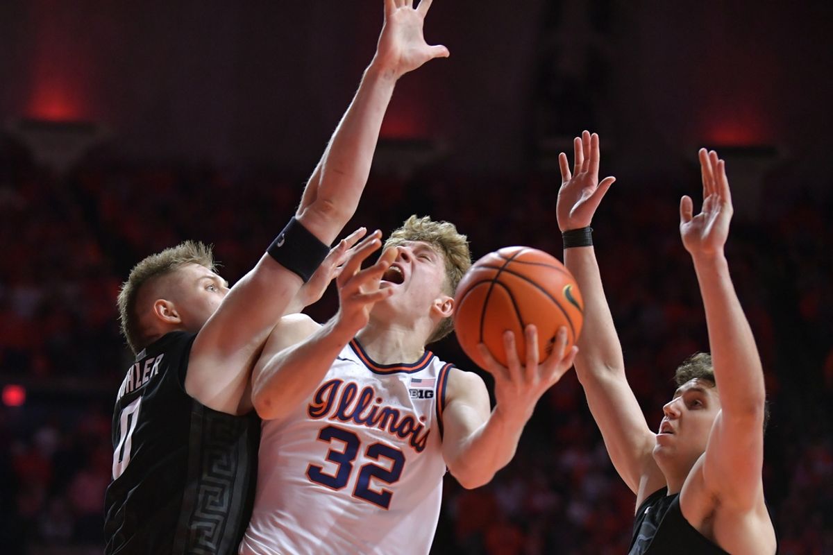 Feb 15, 2025; Champaign, Illinois, USA;  Illinois Fighting Illini guard Kasparas Jakucionis (32) drives to the basket against Michigan State Spartans forward Jaxon Kohler (0) and Szymon Zapala (10) during the first half at State Farm Center. Mandatory Credit: Ron Johnson-Imagn Images