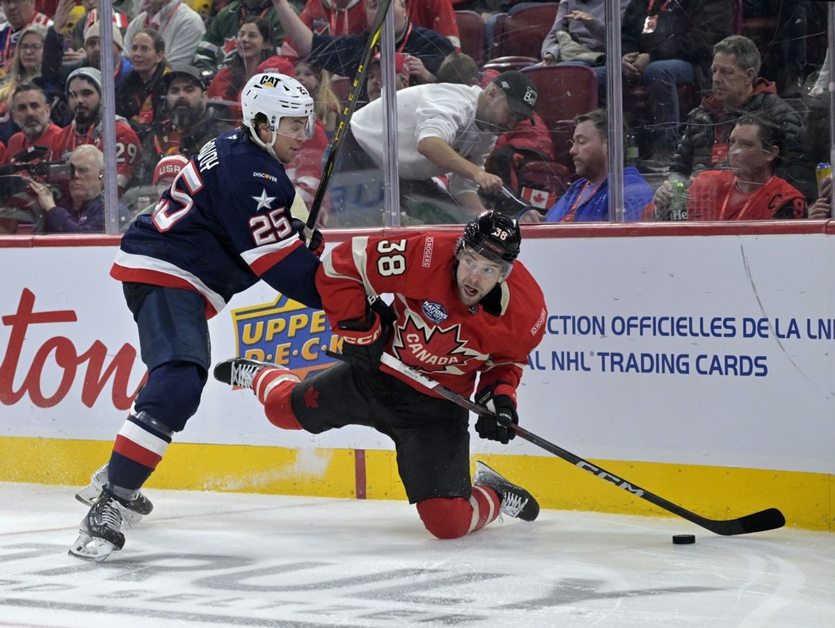 Team Canada forward Brandon Hagel (38) plays the puck and Team United States defenseman Charlie McAvoy (25) defends in the second period during a 4 Nations Face-Off ice hockey game at the Bell Centre. Mandatory Credit: Eric Bolte-Imagn Images