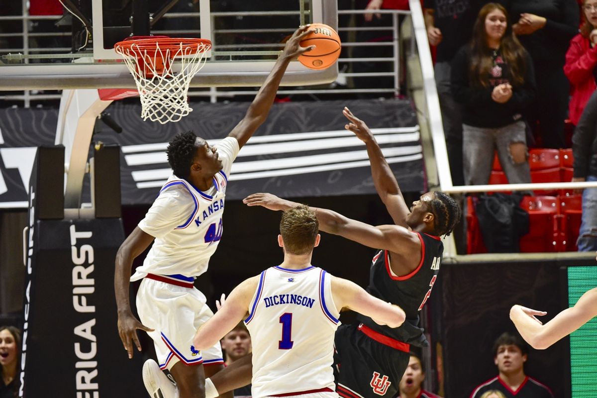 Feb 15, 2025; Salt Lake City, Utah, USA; Kansas Jayhawks forward Flory Bidunga (40) fouls Utah Utes forward Ezra Ausar (2) during the first half at the Jon M. Huntsman Center. Mandatory Credit: Christopher Creveling-Imagn Images