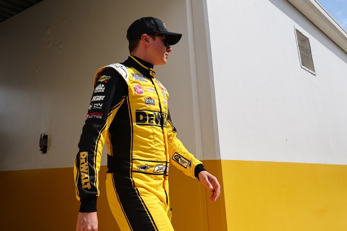 Feb 16, 2025; Daytona Beach, Florida, USA; NASCAR Cup Series driver Christopher Bell (20) walks to the drivers meeting before the Daytona 500 at Daytona International Speedway. Mandatory Credit: Peter Casey-Imagn Images