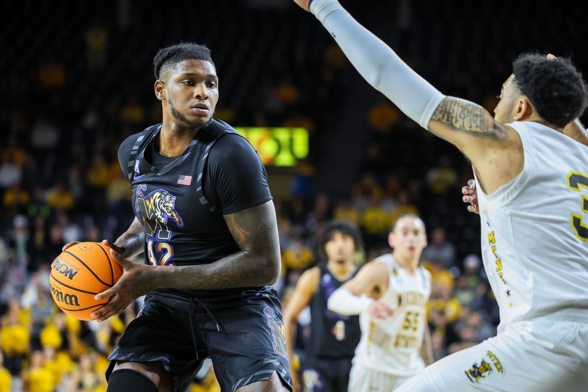 Feb 16, 2025; Wichita, Kansas, USA; Memphis Tigers forward Dain Dainja (42) sets the play during the first half against the Wichita State Shockers at Charles Koch Arena. Mandatory Credit: William Purnell-Imagn Images