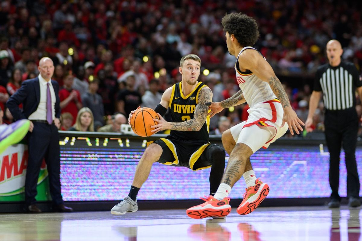 Feb 16, 2025; College Park, Maryland, USA; Iowa Hawkeyes guard Brock Harding (2) handles the ball during the first half against Maryland Terrapins guard Ja'Kobi Gillespie (0) at Xfinity Center. Mandatory Credit: Reggie Hildred-Imagn Images