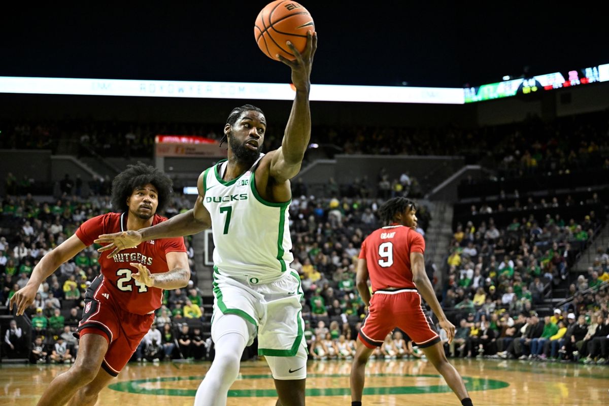 Feb 16, 2025; Eugene, Oregon, USA; Oregon Ducks forward Supreme Cook (7) drives to the basket around Rutgers Scarlet Knights center Lathan Sommerville (24) during the first half at Matthew Knight Arena. Mandatory Credit: Craig Strobeck-Imagn Images