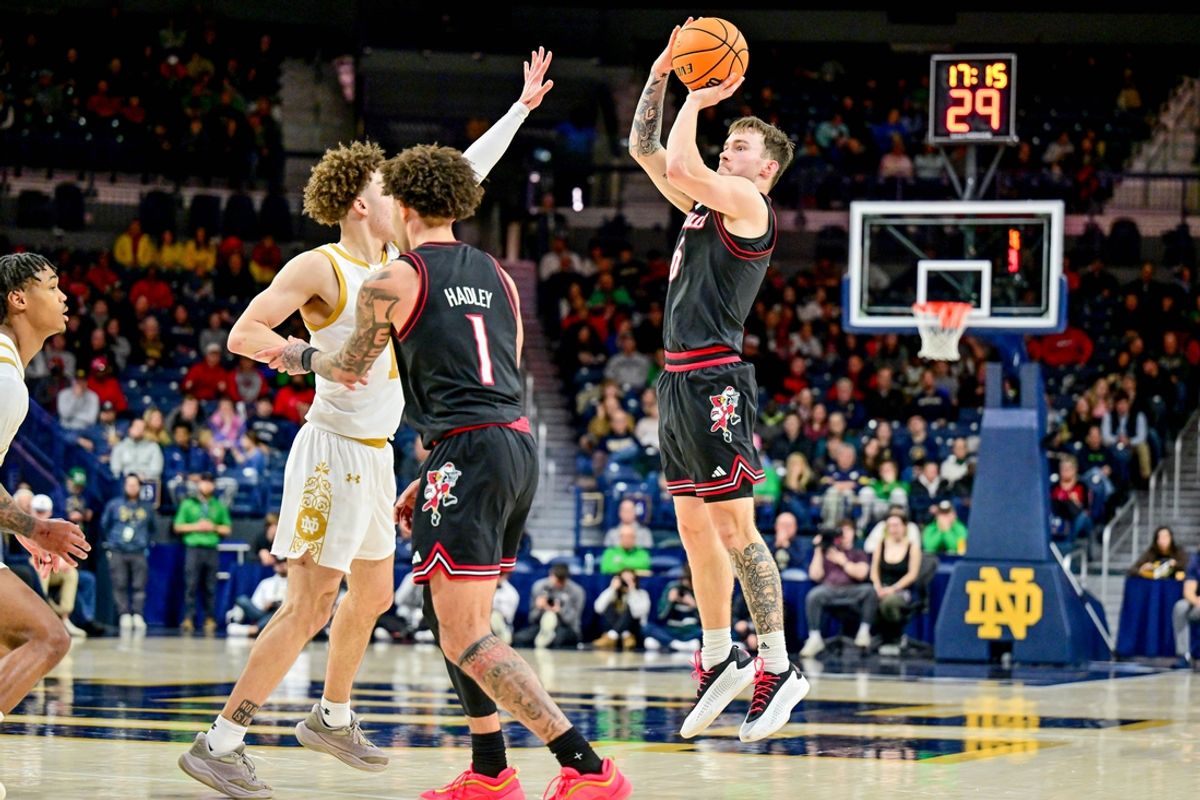 Feb 16, 2025; South Bend, Indiana, USA; Louisville Cardinals guard Reyne Smith (6) shoots a three point basket over Notre Dame Fighting Irish guard Braeden Shrewsberry (11) in the second half at the Purcell Pavilion. Mandatory Credit: Matt Cashore-Imagn Images